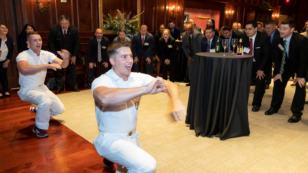 Yell leaders lead a yell for METM students