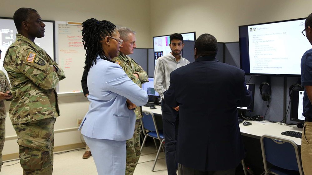 Student presents to group of people. 