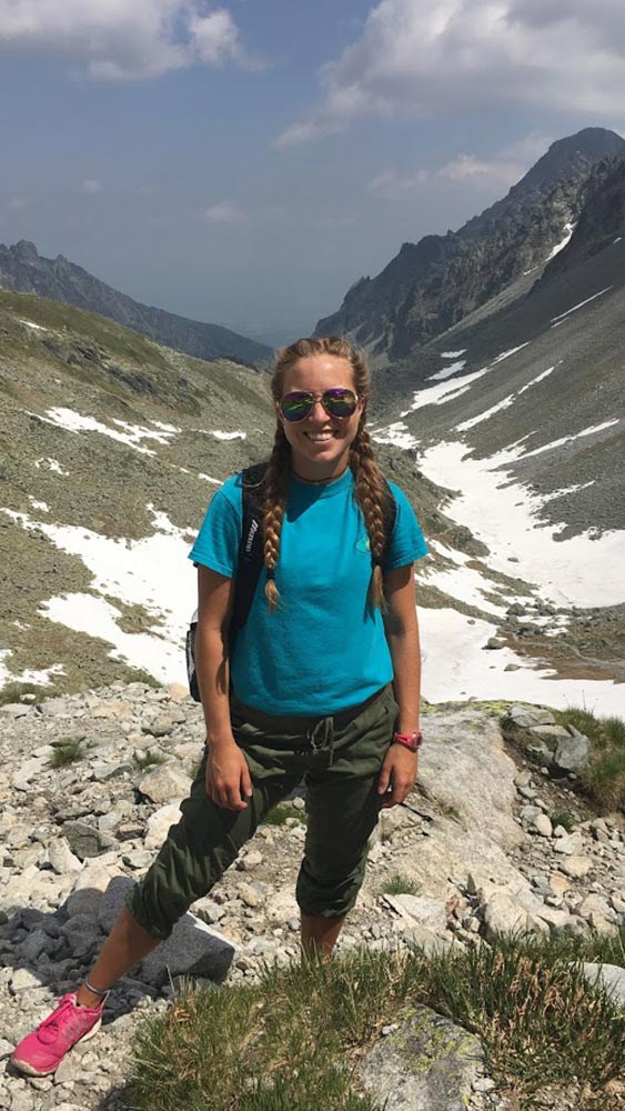 Allison Van Beveren standing in front of mountains.