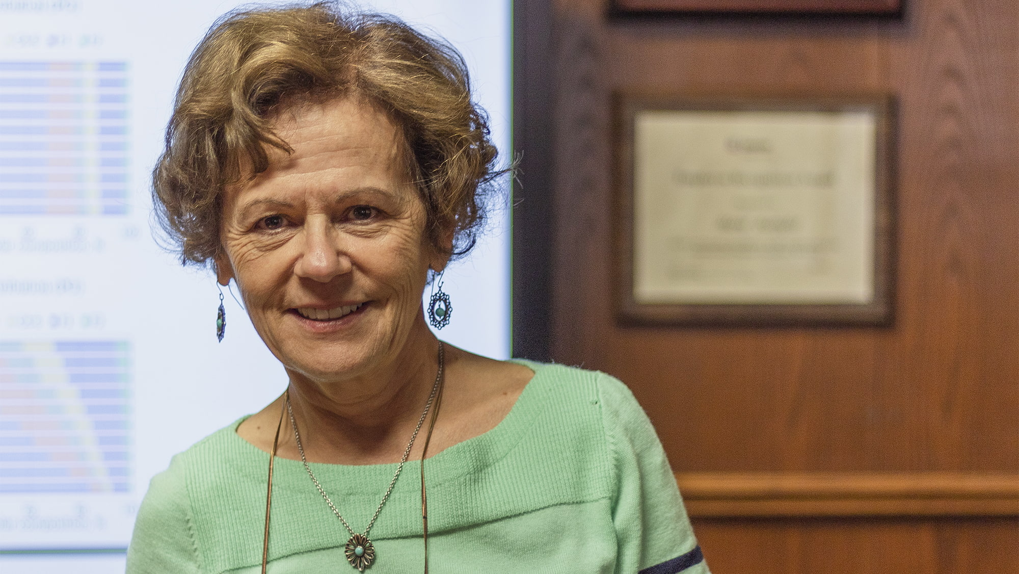 Dr. Maria Barrufet stands in front of screen showing research results