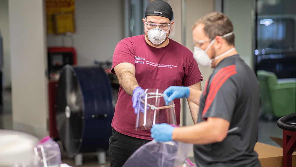 Technician in the Fischer Engineering Design Center packaging face shields. 