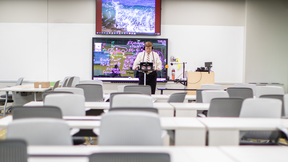 A professor teaching to an empty classroom