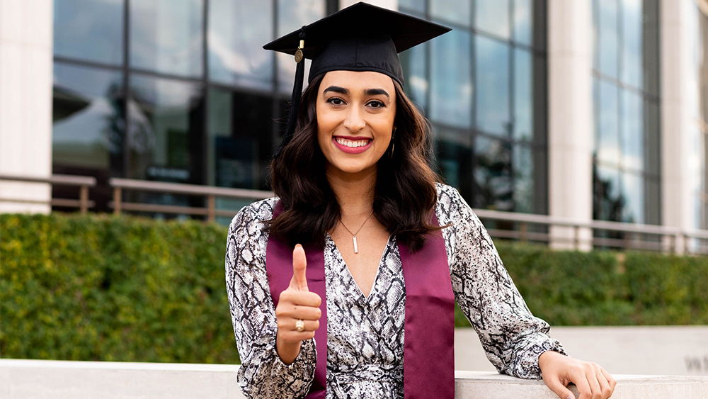 Allison Godfrey smiling with her Aggie ring.