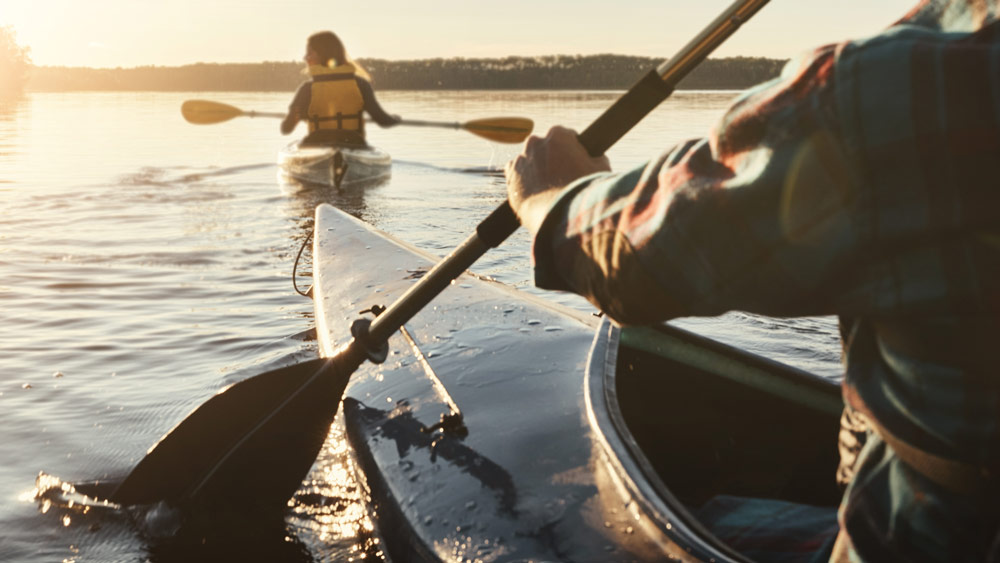 A man and woman canoeing on a lake