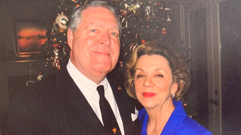 Jean P. and William M. Jensen standing in front of a Christmas tree. 