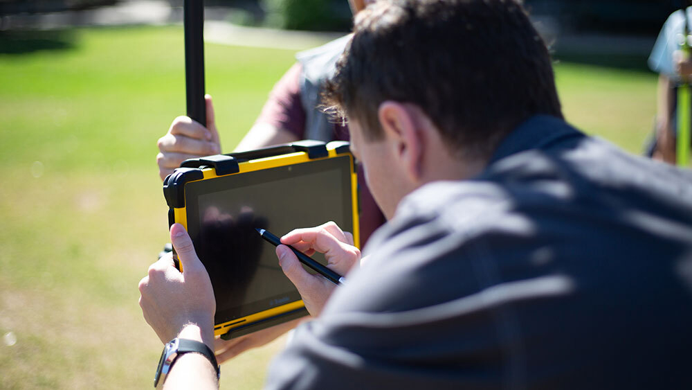 Student working on a surface-like tablet with a stylus.