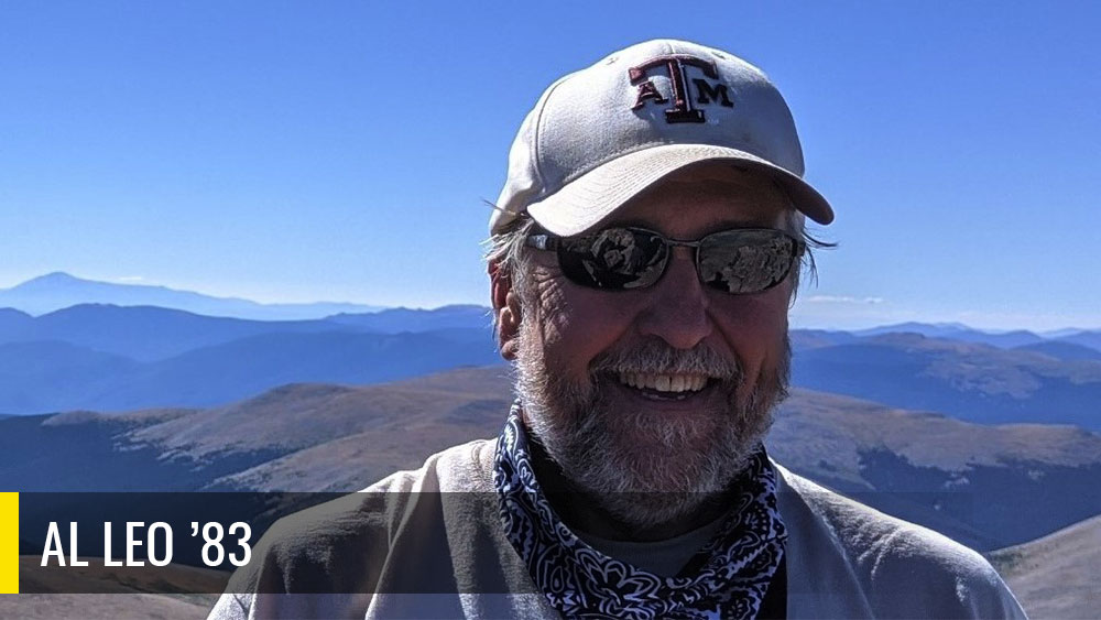 Al Leo taking a photo in front of Mountains.