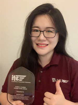 Xiaoyu “Sky” Guo with an award 