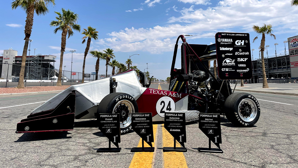 car with trophies in front 