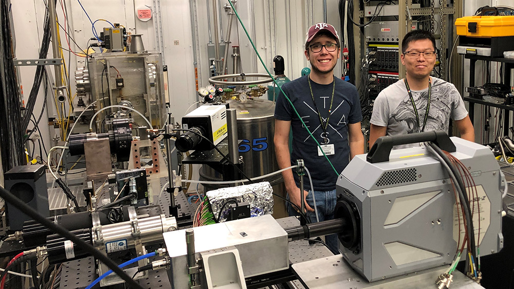 Two graduate research assistants posing in the high-speed X-ray lab.