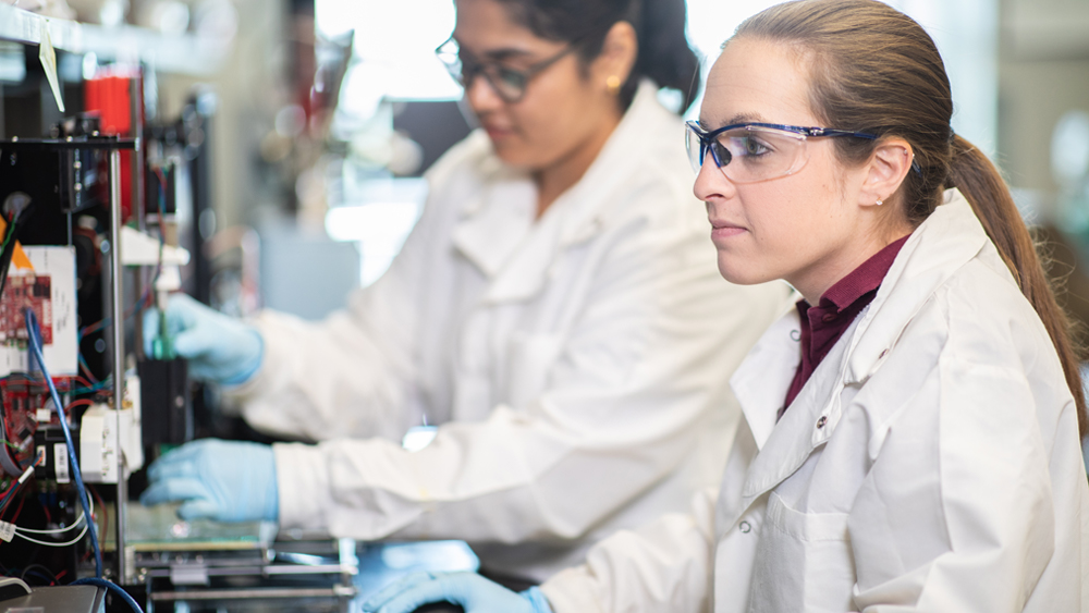 Female student works with computer equipment in lab