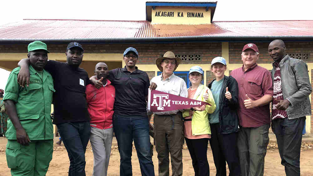 A group of people holding a banner 