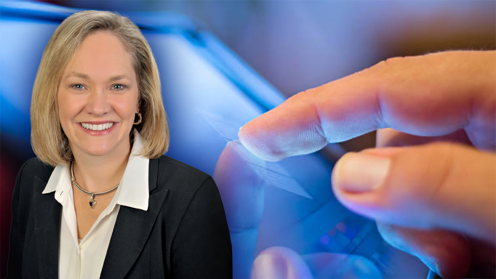 Dr. Cynthia Hipwell in front of an image of a hand interacting with a touchscreen.