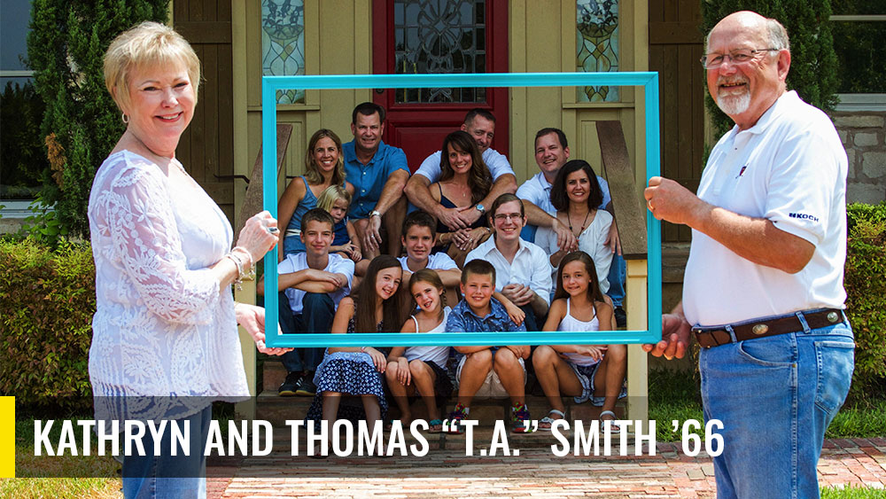 Kathryn and Thomas Smith with their children and grandchildren sitting on the outside steps of a house posing for a family photo. 