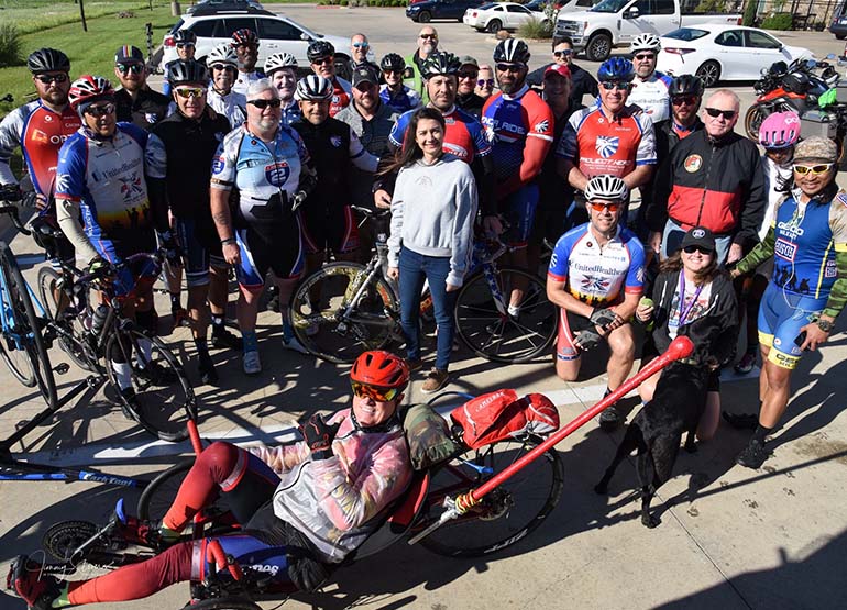 Mahnoosh poses in the middle of a large group of cyclists