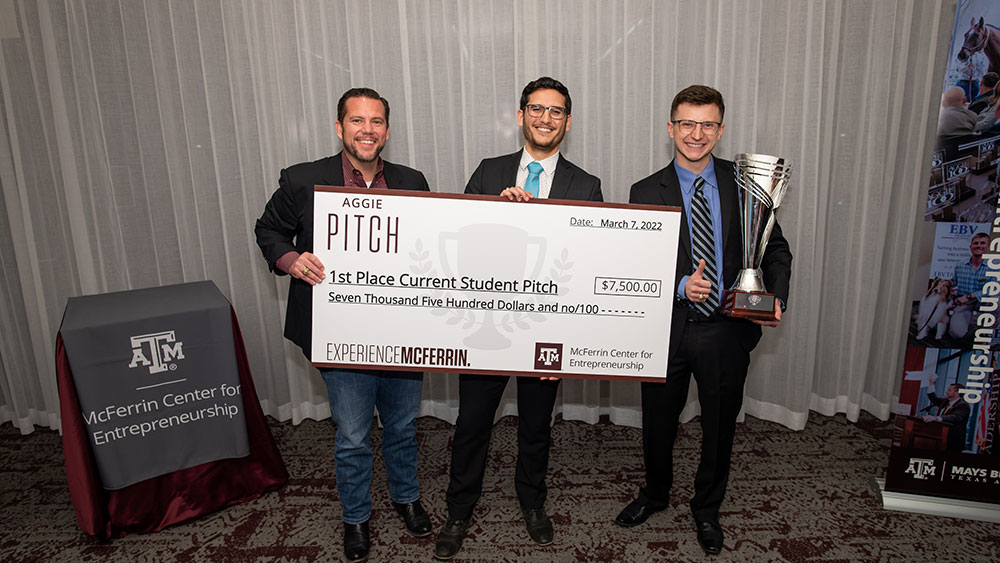 Blake Petty, Daniel Zamarron and Bryton Praslicka holding large check