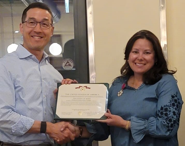 Two people with a certificate looking at the camera