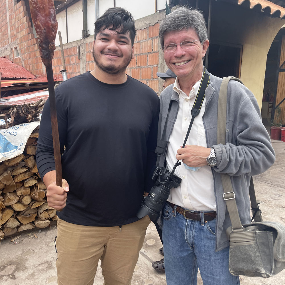 A student and a professor pose at an eatery in Peru