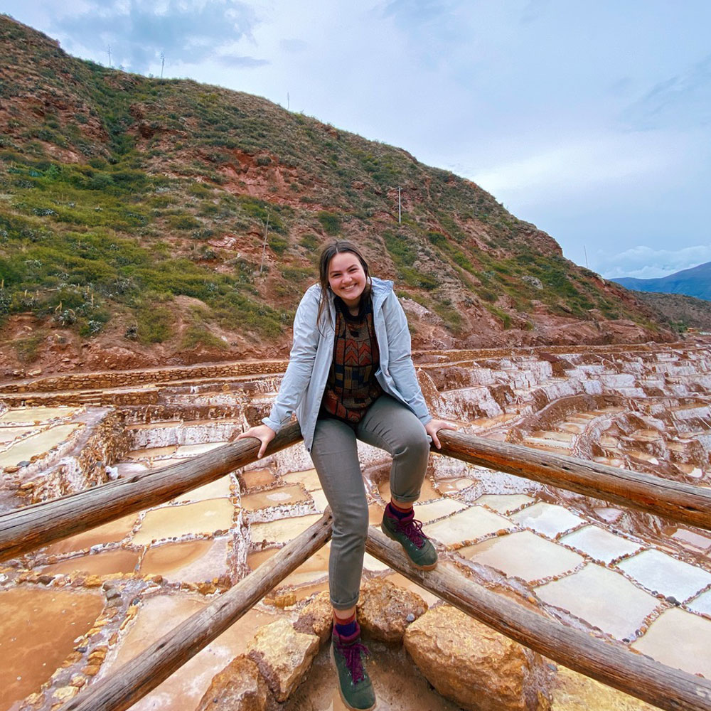 A students stands at an overlook at the Sacred Valley of the Incas in Peru