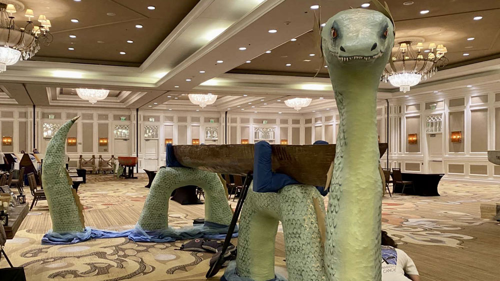 A canoe rests on a giant serpent display 