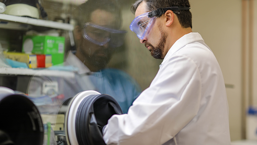 Researcher Sean Martinson purifying a plutonium solution in a nuclear forensics laboratory at Texas A&amp;M University.