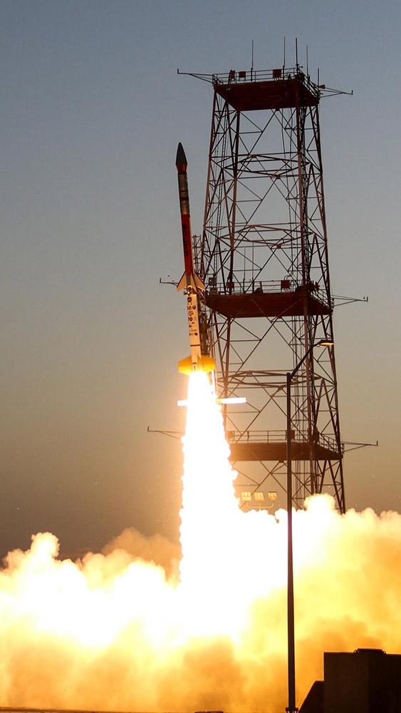 The BOLT II sounding rocket launching with flames and smoke coming out from the bottom of the rocket.