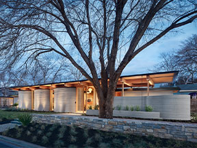 Exterior photo of a 3-D printed house created by ICON