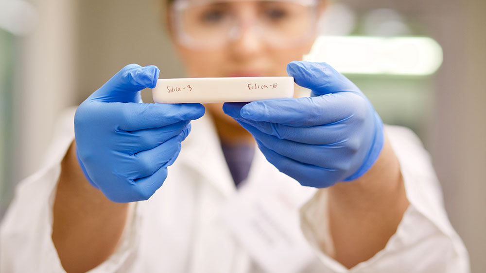 Texas A&M engineering student holding a piece of polymer