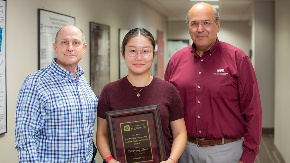 Dr. Jim Boyd, Tiayang Zhou holding her award and Dr. Dimitris Lagoudas