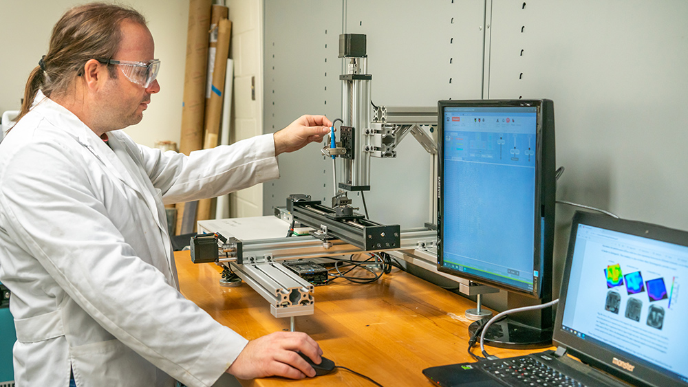 Dr. Daniel Salas demonstrates how the hidden magnetic tag can store a cache of information within an item. 