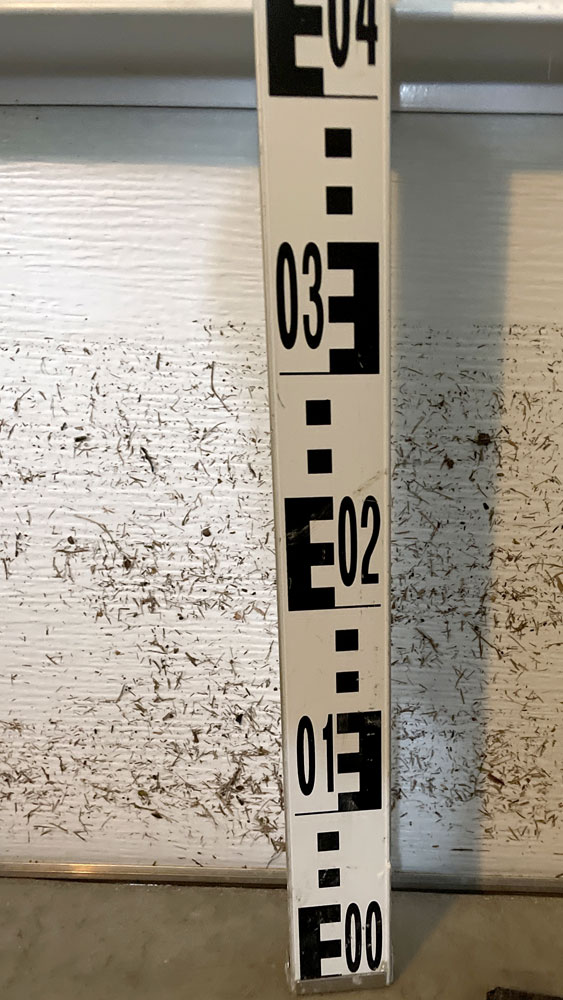 A ruler shows the water line rose more than a foot above the floor  