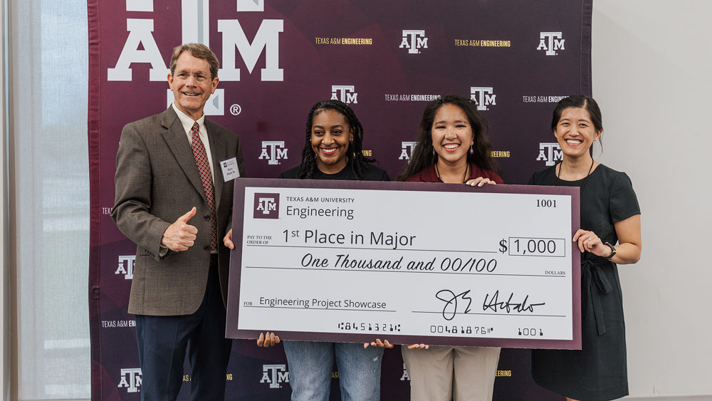 The first-place winning team members stand with their instructors and Dr. Harry Hogan at the awards ceremony of the Engineering Project Showcase.