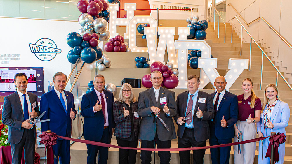 A group of people at a ribbon cutting event for the new Industrial Distribution Building