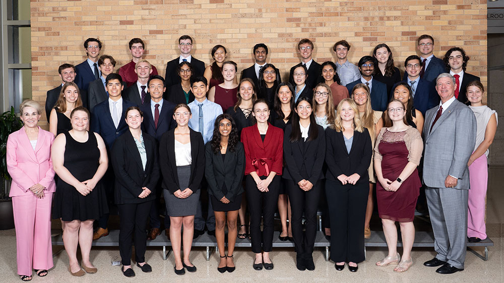 A large group of students and donors standing together