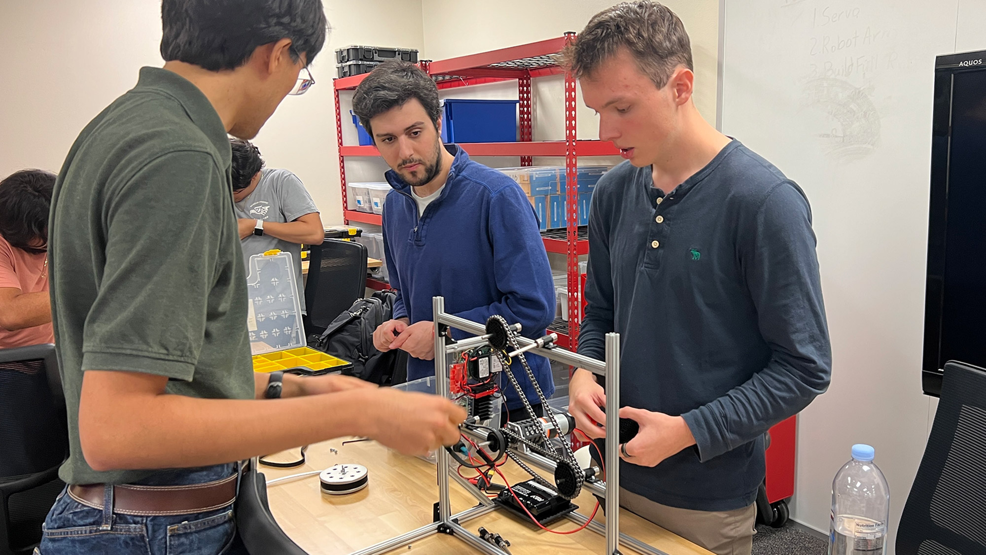 Five students working on a robotics project.