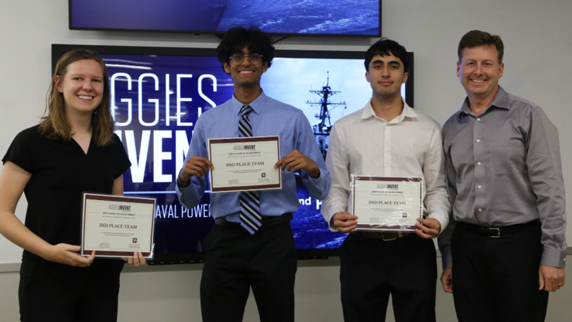 Winning students holding second place certificates.