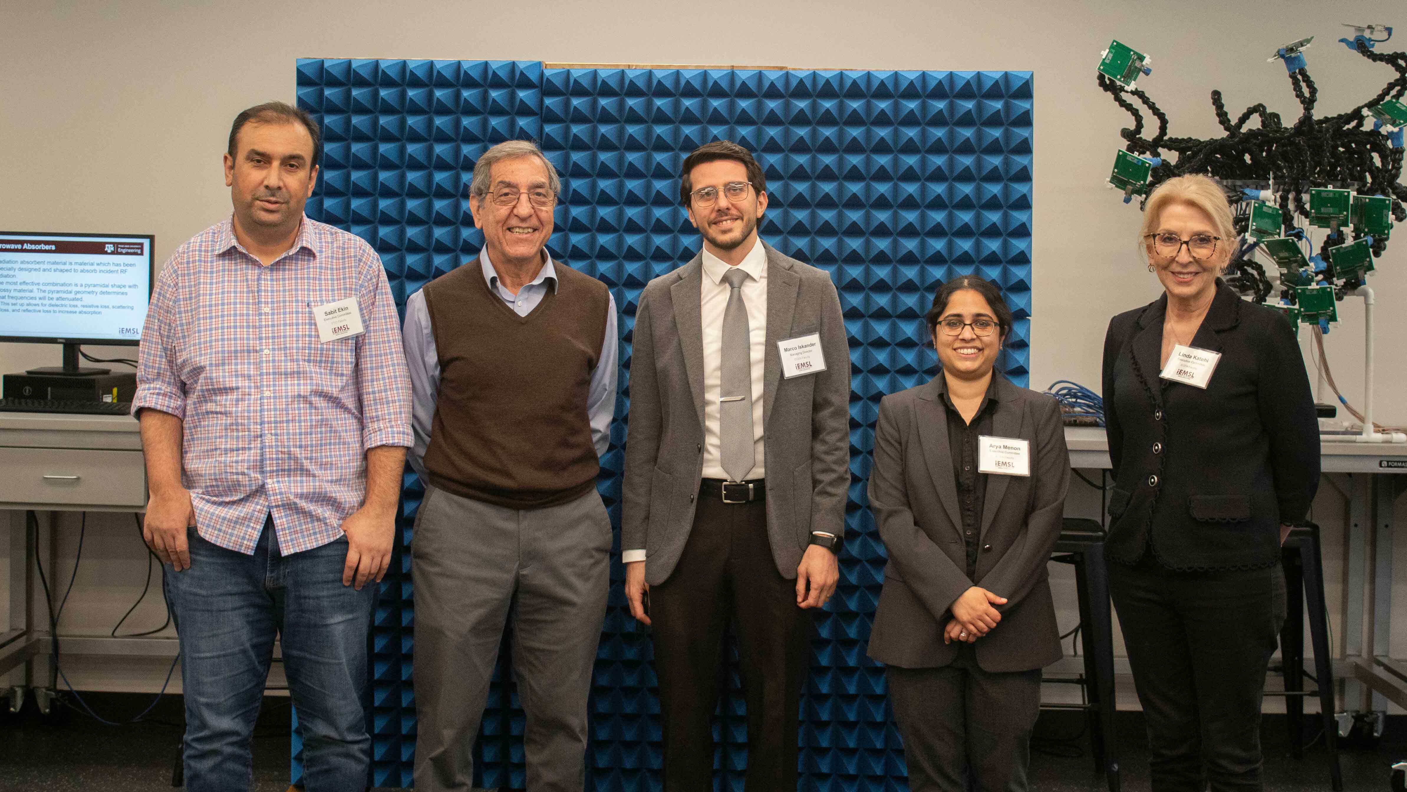 Five people standing in a lab.