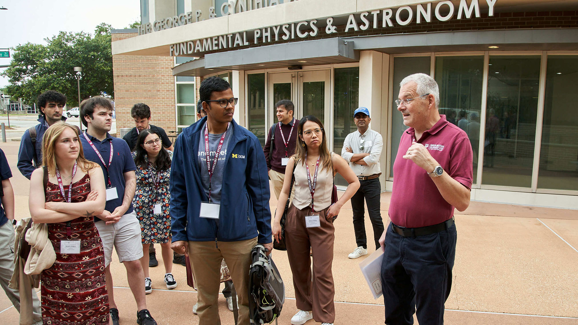 A group of students on tour outside a building.