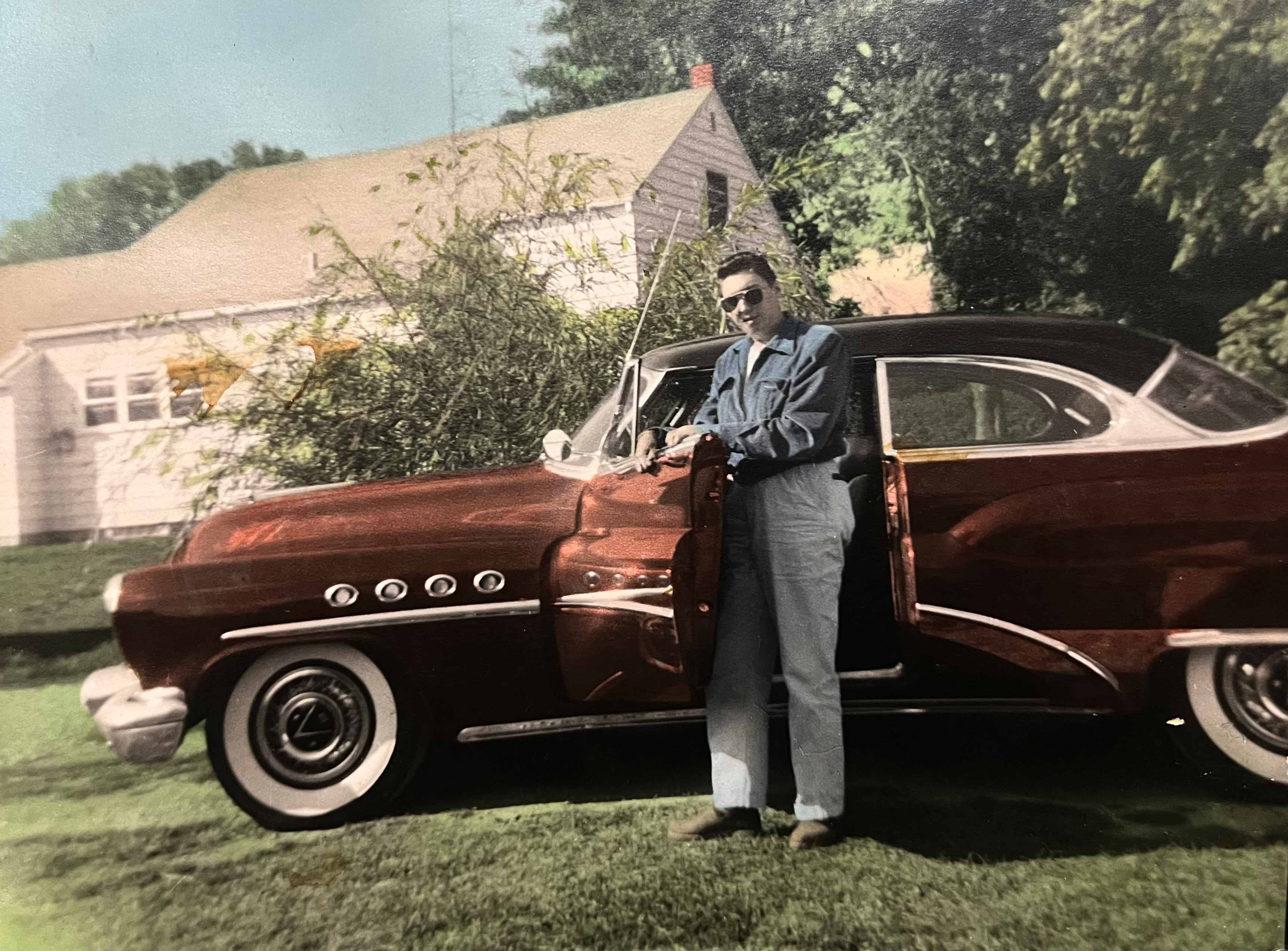 A man standing next to a car.