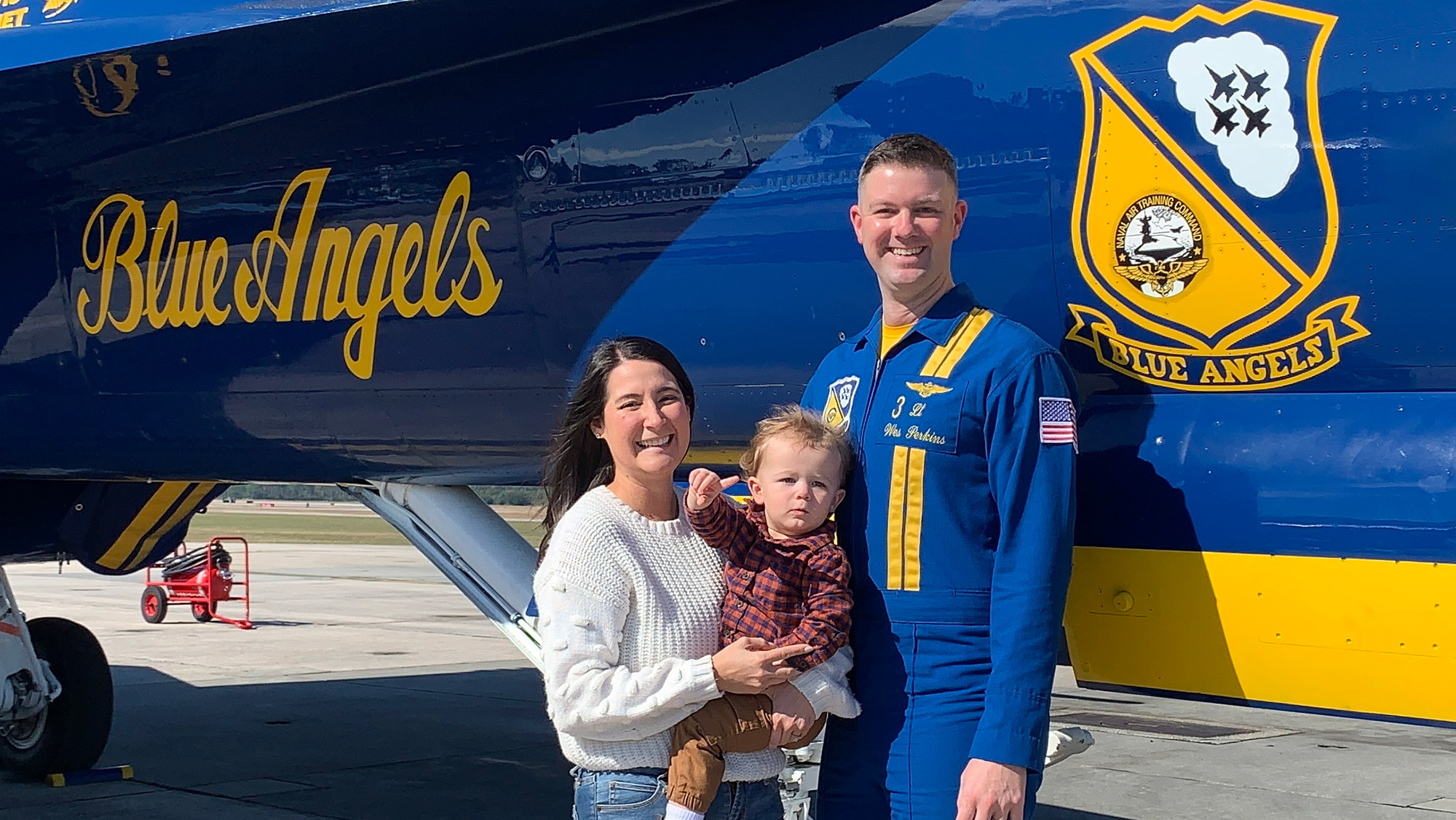 A family posing in front of a plane.