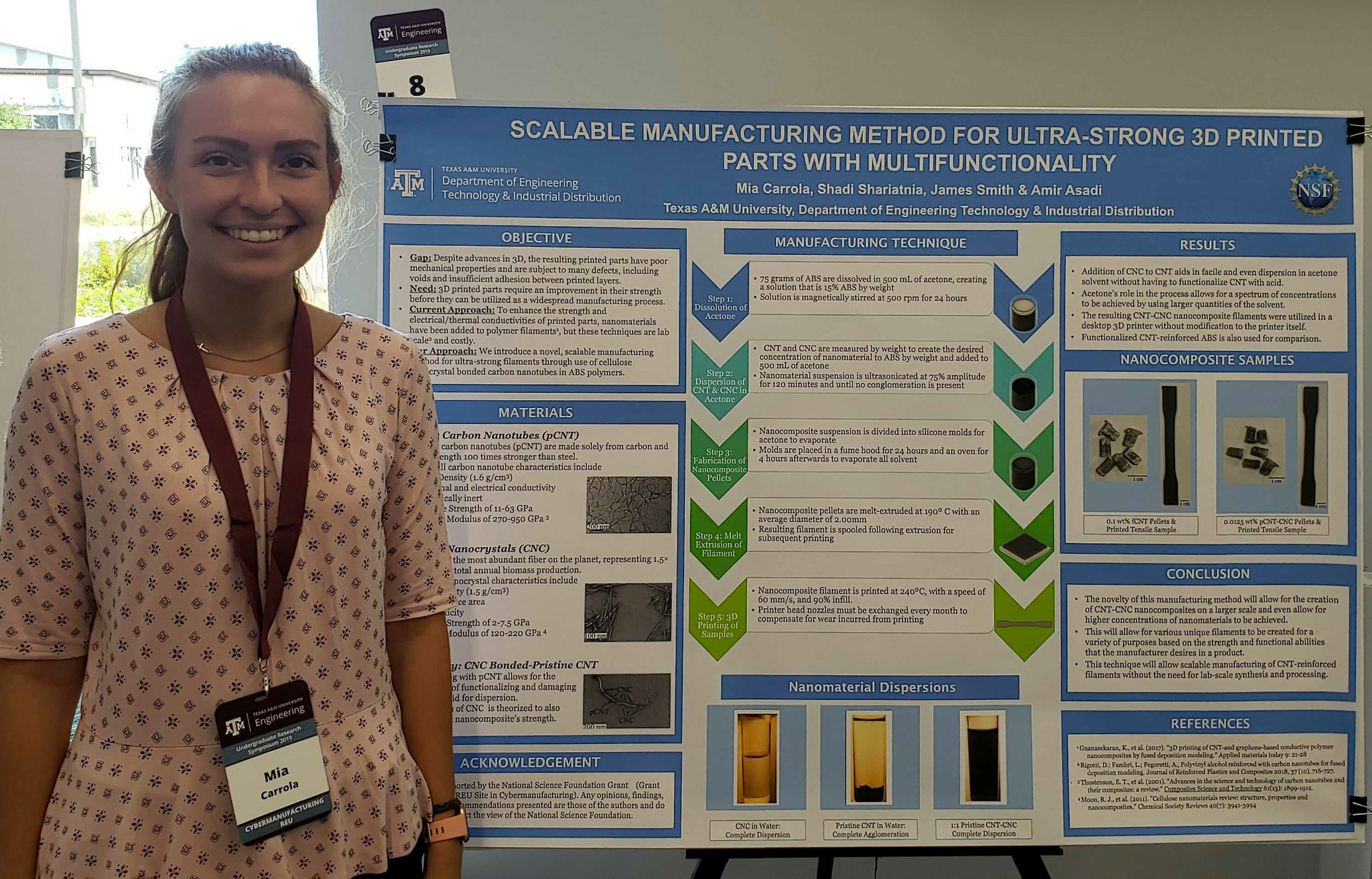 A smiling woman stands by presentation board.