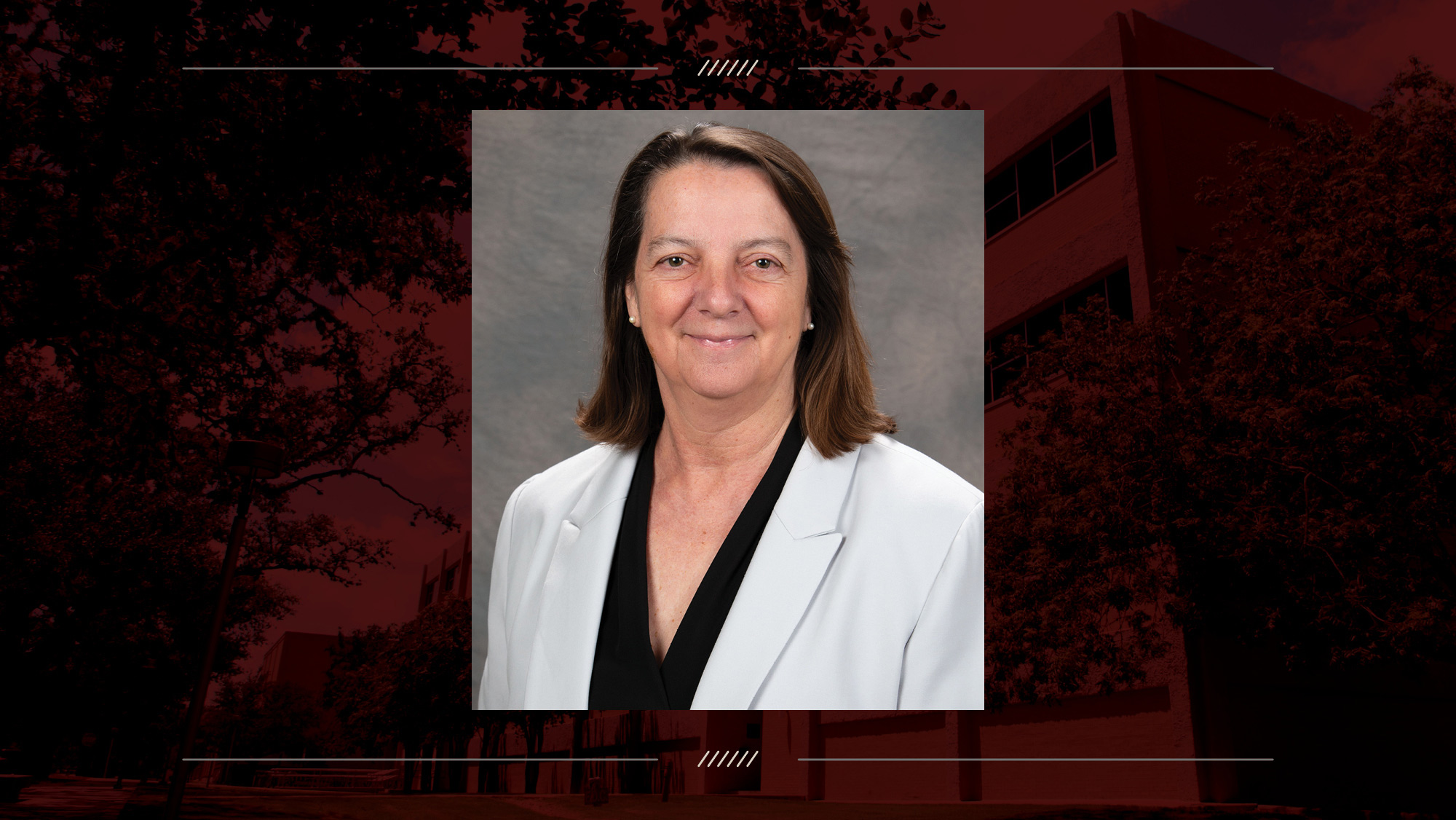 Female in a white suit jacket on a maroon background.