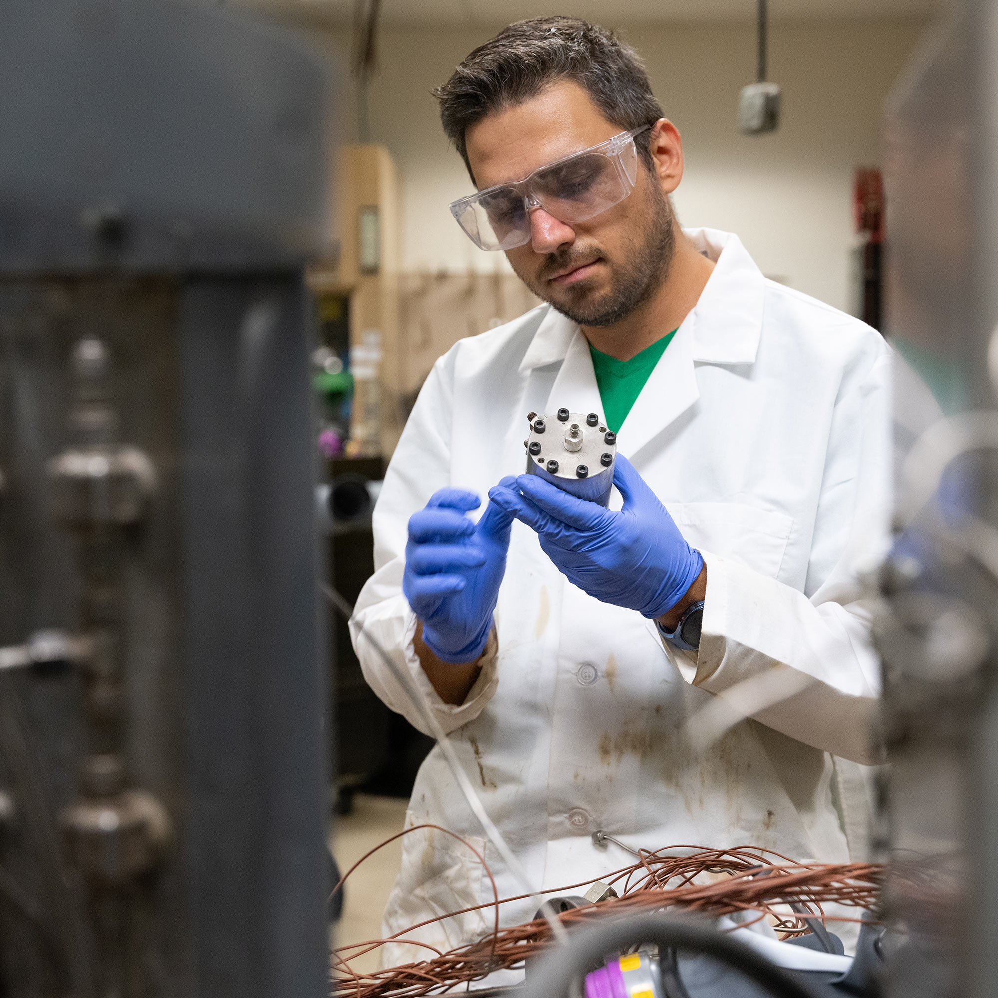 Student working on machinery in lab.  