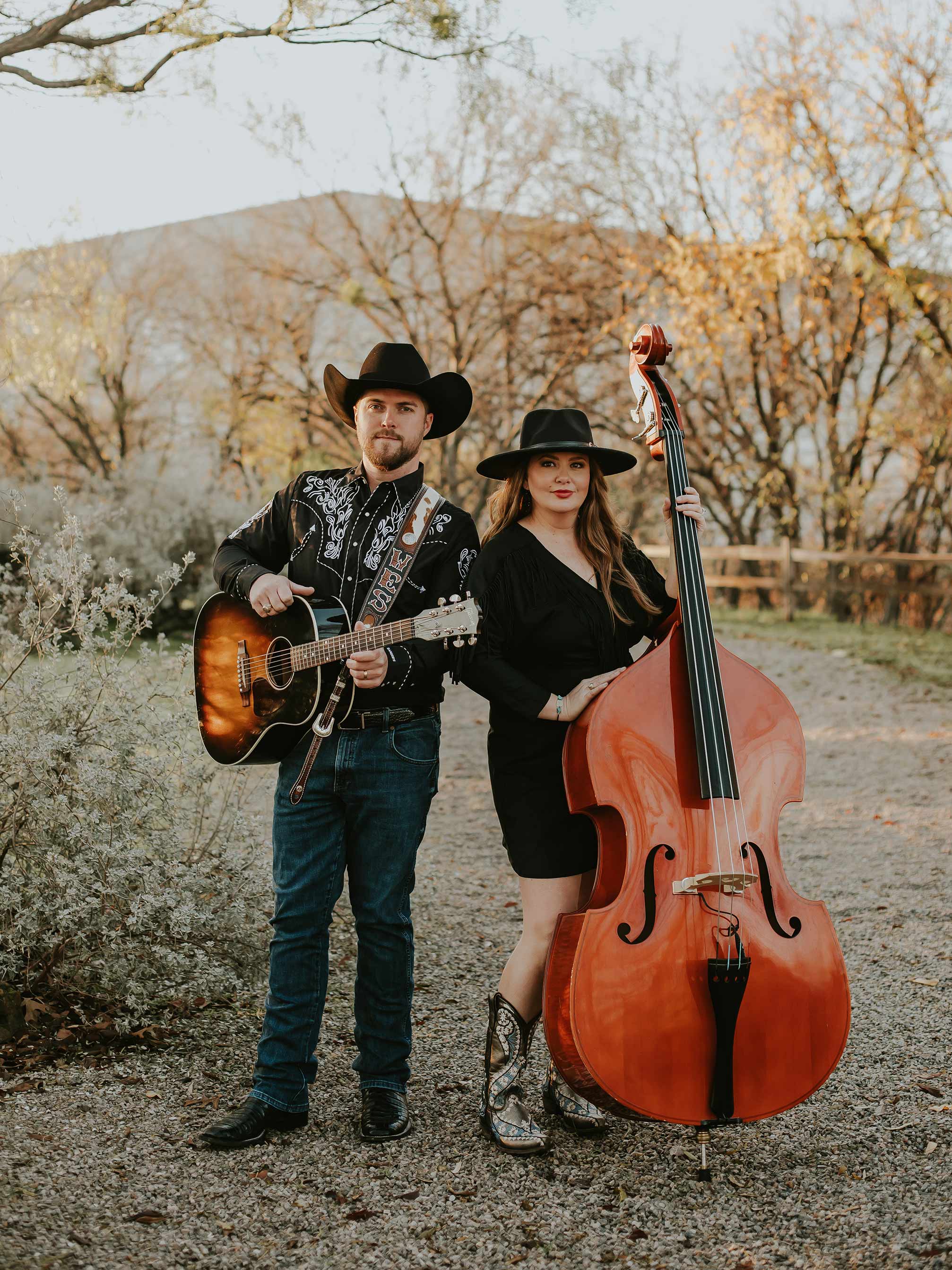 Man and woman pose with instruments.