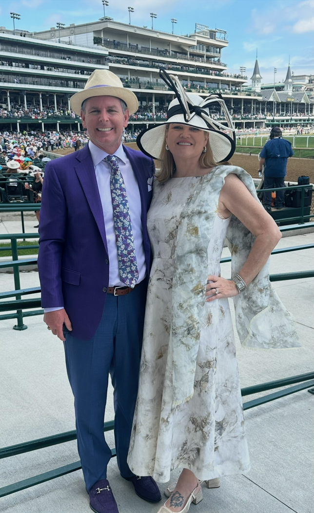 A couple attends a horse race.
