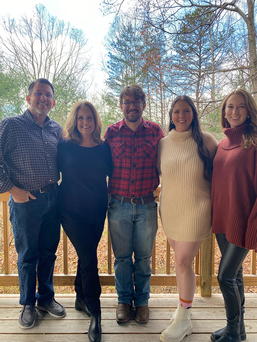 A picture of a couple with their three adult children.