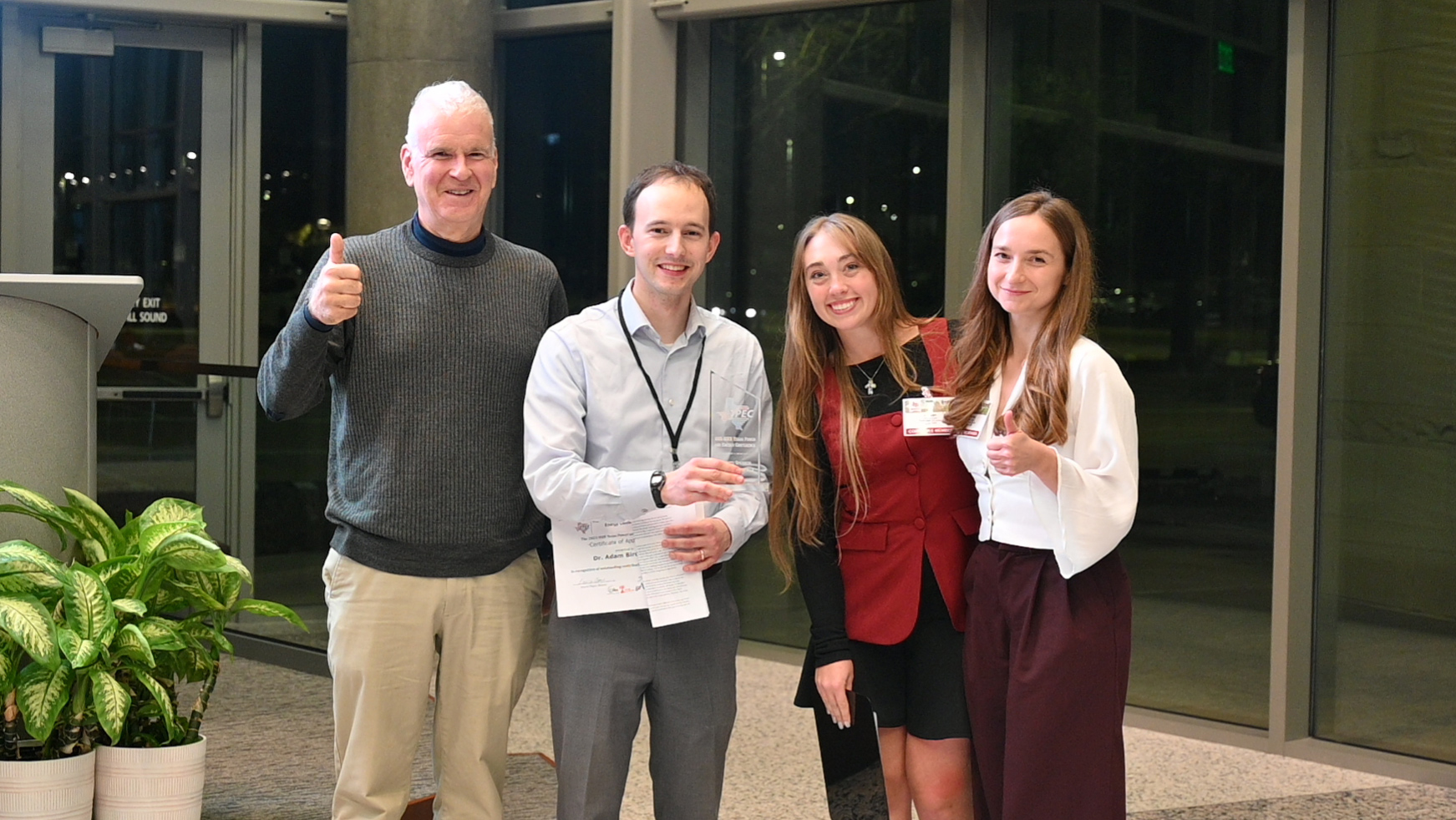 Four people attending a conference.