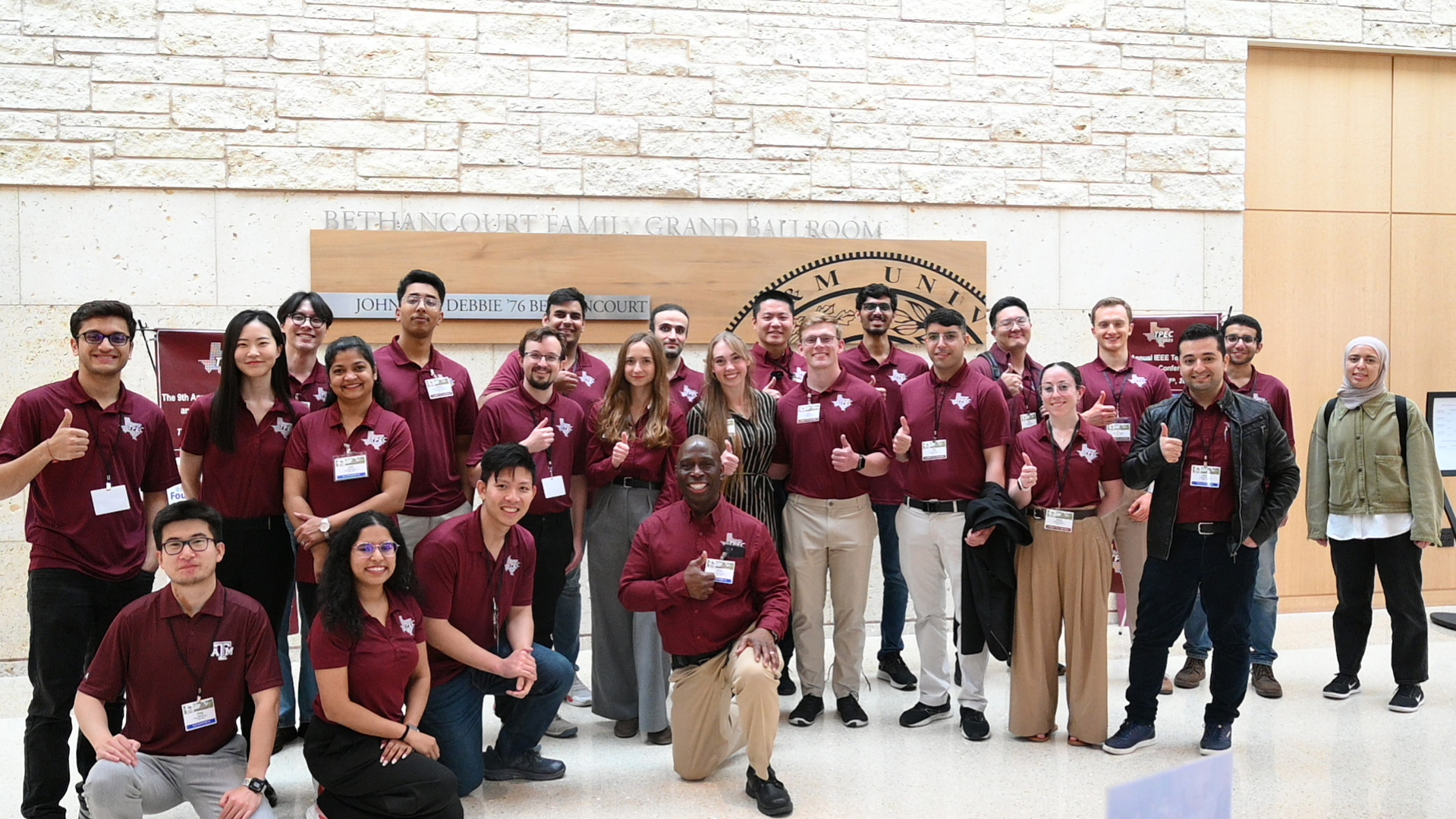 A group of people giving thumbs up.