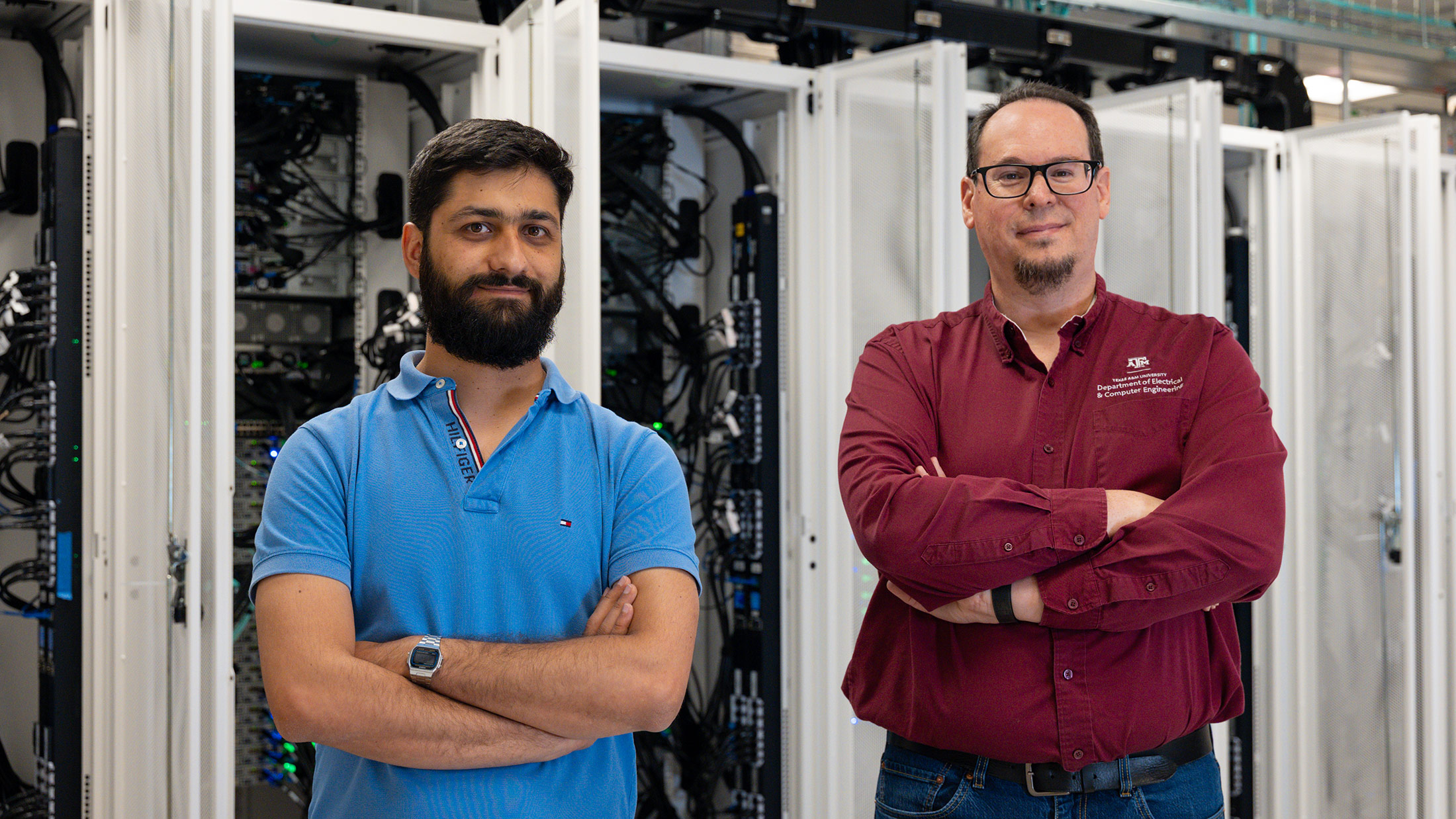 Two men standing in front of lab equipment.