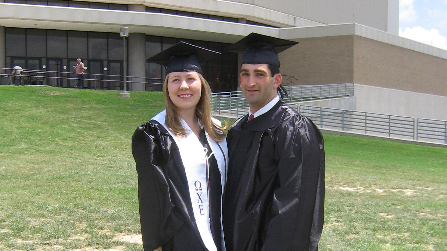 Two graduates posing for a picture.